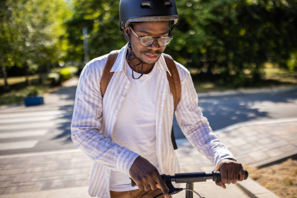 istock Young businessman going home after work with push scooter 1344248110