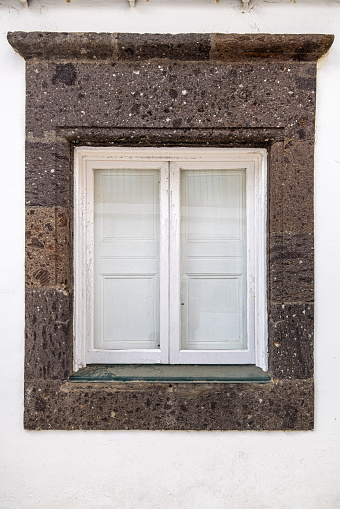 Traditional window with inside shutters in Ponta Delgada the main city on the Portuguese Azorean Island San Miguel in the center of the North Atlantic Ocean