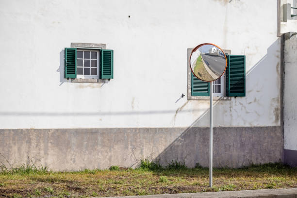 Street mirror and windows with shutters in Ponta Delgada the main city on the Portuguese Azorean Island San Miguel in the center of the North Atlantic Ocean