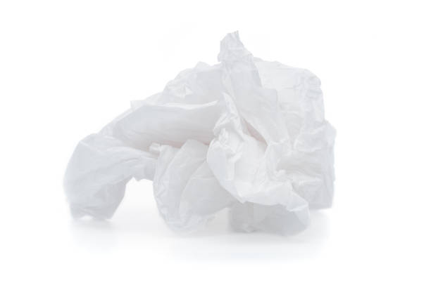 istock Crumpled paper ball close up on white background 1344250240