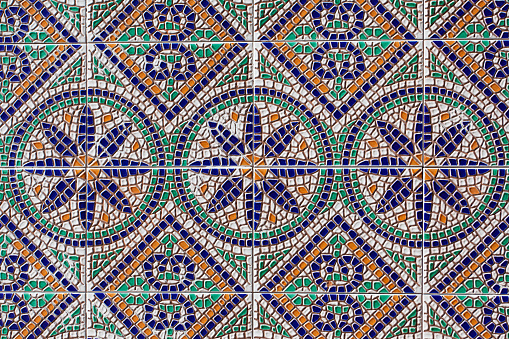 Ancient mosaic with colorful geometric and floral patterns closeup