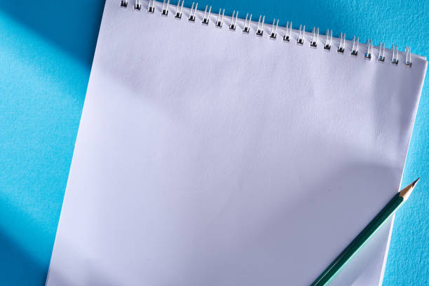 istock blank sketch book  on the blue background 1344250743