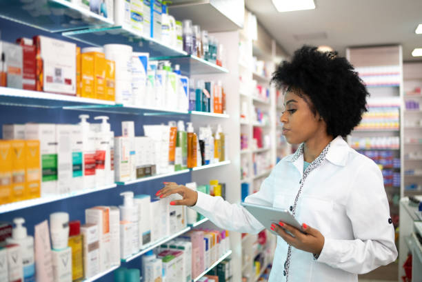istock Young pharmacist checking the shelves with a digital tablet at the pharmacy 1344251501