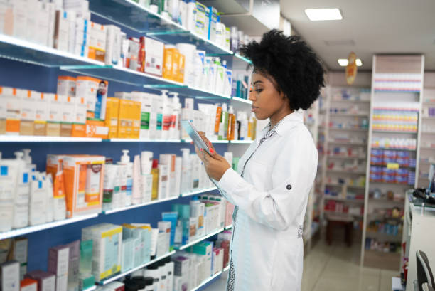 istock Young pharmacist checking the shelves with a digital tablet at the pharmacy 1344251551