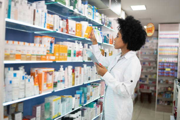 istock Young pharmacist checking the shelves with a digital tablet at the pharmacy 1344251560