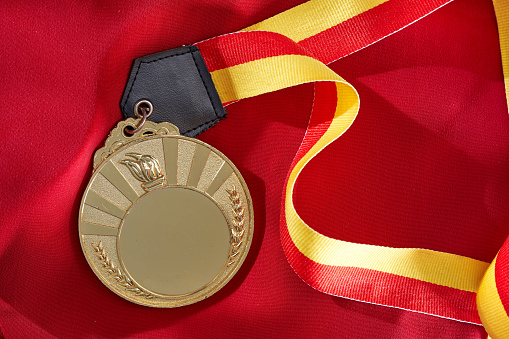 golden medal  on red satin cloth