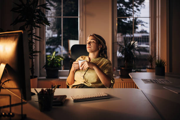 One woman, young business woman napping while working late on computer in office,