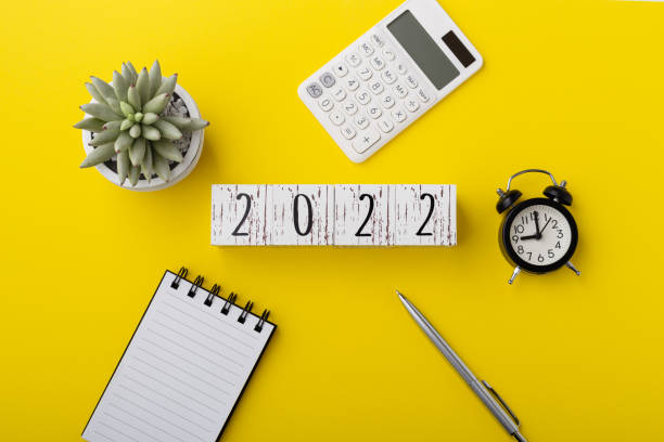 istock 2022 wood block with calculator and notebook on yellow background 1344252896