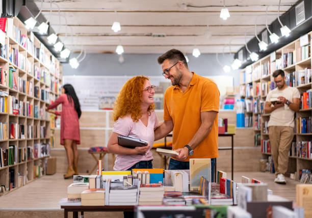 istock Curious young couple at the modern bookstore, choosing the books for them 1344252901