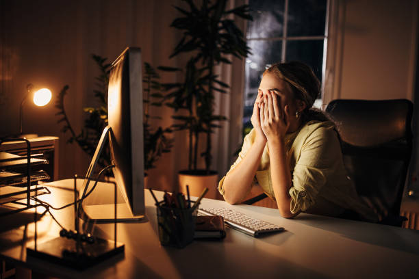 istock Tired woman working late in office 1344253306
