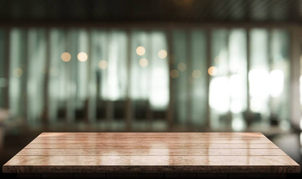 istock Empty wooden table top with lights bokeh on blur restaurant background 1344253335