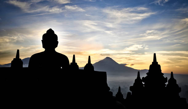 Famous Buddhist Temple Borobudur at Sunrise. (View to the volcano Merapi)Yogyakarta, Island Java - Indonesia
