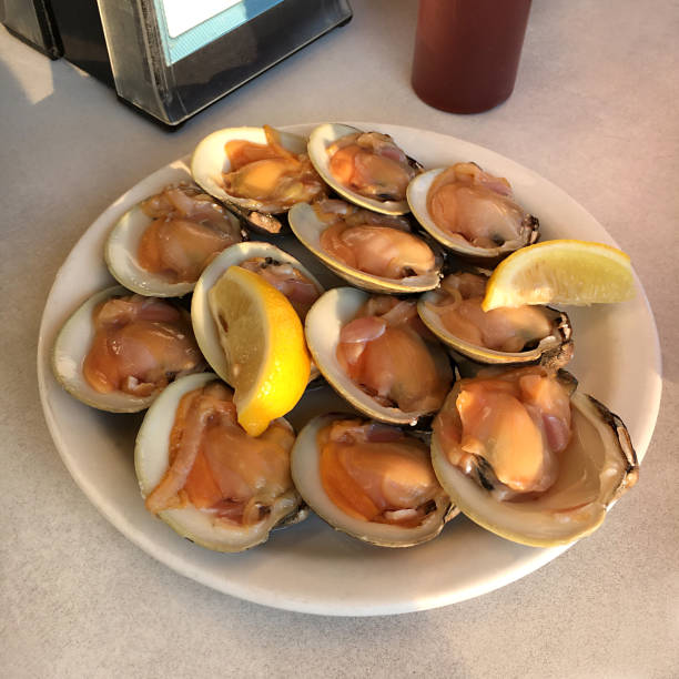 A Dozen Raw Clams with Lemons and Hot Sauce