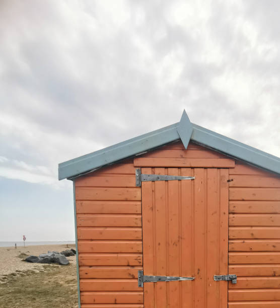 istock Old dark orange weathered shed beside beach 1344255532