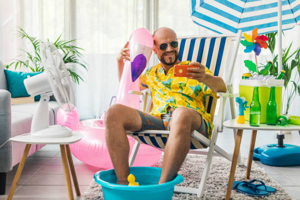 istock Man spending summer vacations at home and taking selfies 1344258370