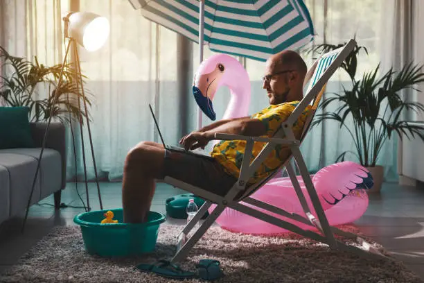 Photo of Man working from home during summer