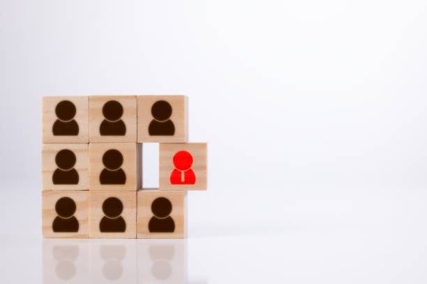 istock Different thinking and human development concept distinguishes the red management icon from the staff employee icon printed on a wooden block. 1344258401