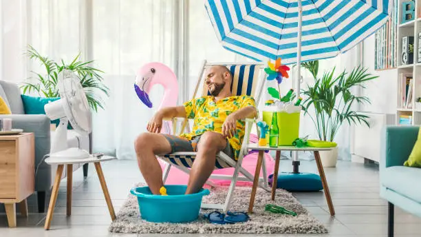 Photo of Man having a staycation and resting on a deckchair at home