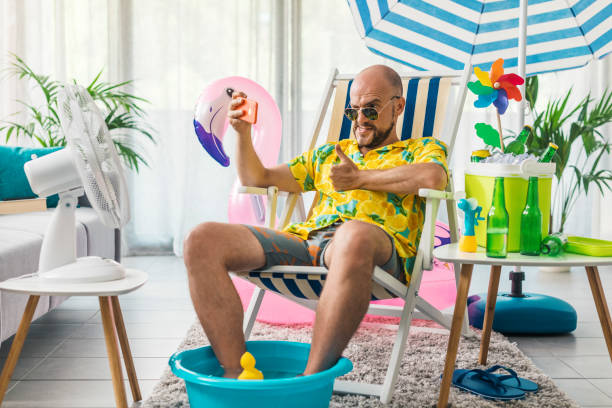 istock Man spending summer vacations at home and taking selfies 1344258491