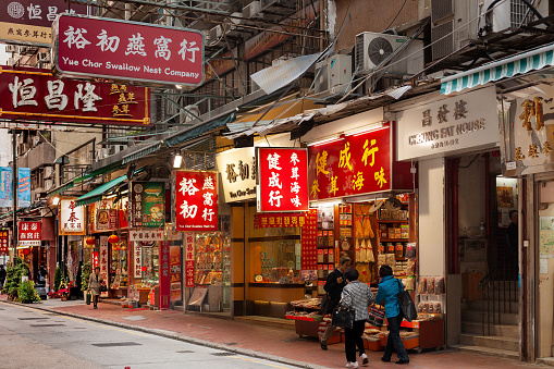 Sheung Wan, Hong Kong Island, Hong Kong, China, Asia - December 04, 2008: Stores and sings on a commercial street at Western Hong Kong.
