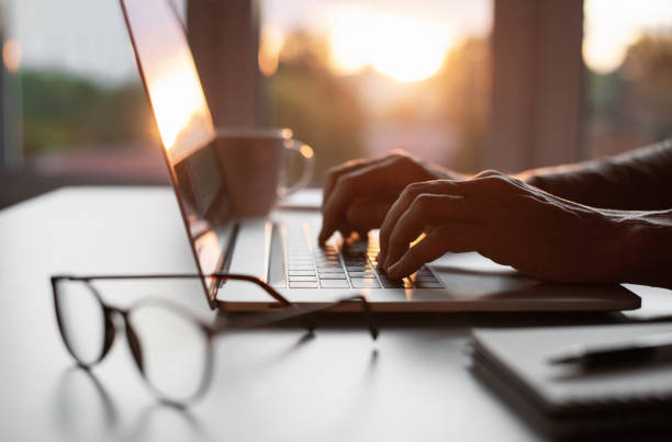 istock Businessman or journalist working on laptop in office 1344259474