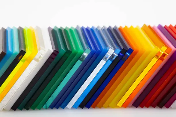 Photo of Colorful acrylic sheets plastic samples on white background , equipment for creativity and decoration