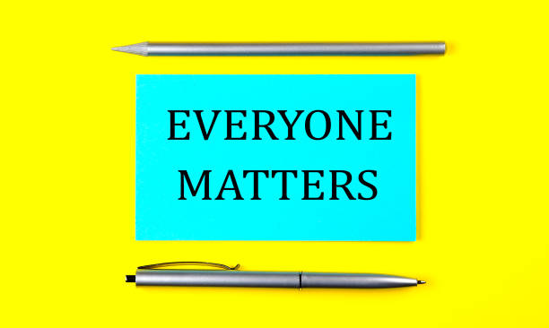 istock text EVERYONE MATTERS on the blue sticker on the yellow background 1344268086