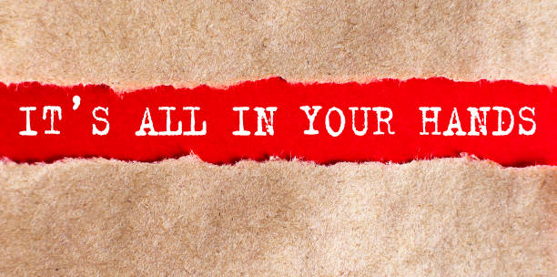 istock IT'S ALL IN YOUR HANDS word written under torn paper on red background, business 1344268092