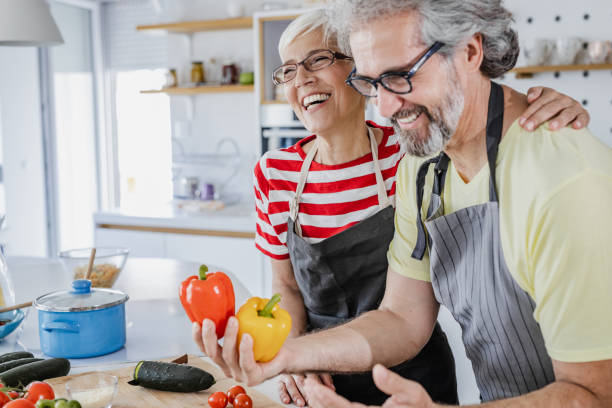 istock Senior couple cooking together at home 1344270541