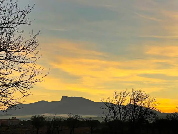 Beautiful colourful light effects paint the dawn skies at sunrise to create dramatic skies in northern Majorca, Balearic Islands, Spain