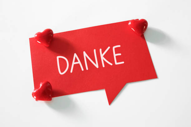 danke (thank you in german language) word written on speech bubble stock photo