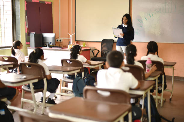 istock Teacher taking students attendance in classroom 1344271079