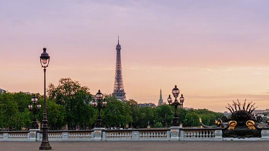Sunset on Alexandre III bridge and Tour Eiffel in background .