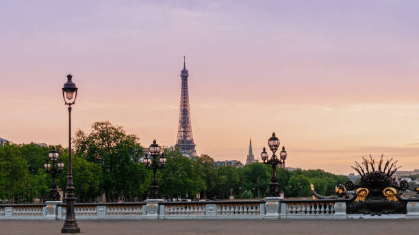 Sunset on Alexandre III bridge and Tour Eiffel in background . stock photo