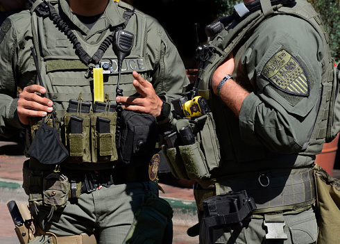 Santa Fe, NM, USA - September 12, 2021: Two members of the Santa Fe Police Department SWAT team talk while on duty at an outdoor festival.