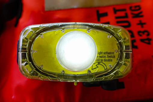 Photo of close up emergency lighting on life jacket, activates by water.
