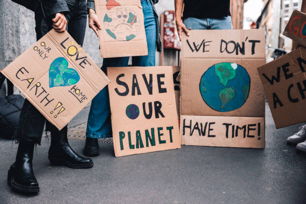 istock Close up on a group of activists holding their handmade protesting messages 1344274634