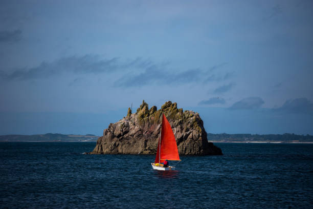 Blue Mediterranean Sea, clear skies and a sailing ship with white sailing and a lot of sailboats. Regatta. Spain