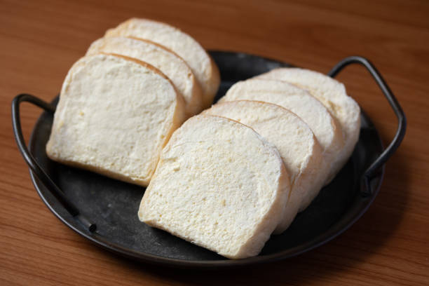 istock brown buttered bread on wooden background 1344277117