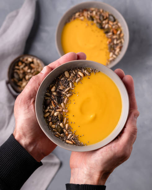istock hands holding a bowl of pumpkin soup 1344280890