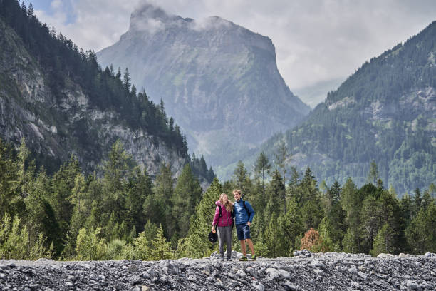 istock Friends hike down forested trail in the morning 1344280945