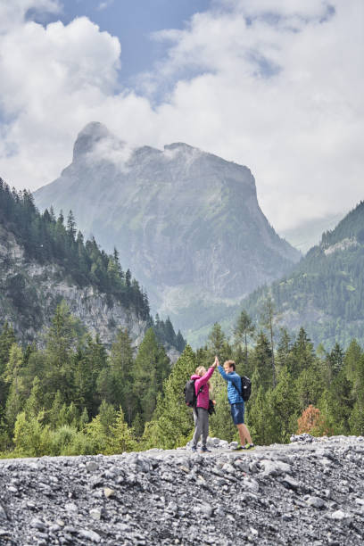 istock Friends hike down forested trail in the morning 1344281010