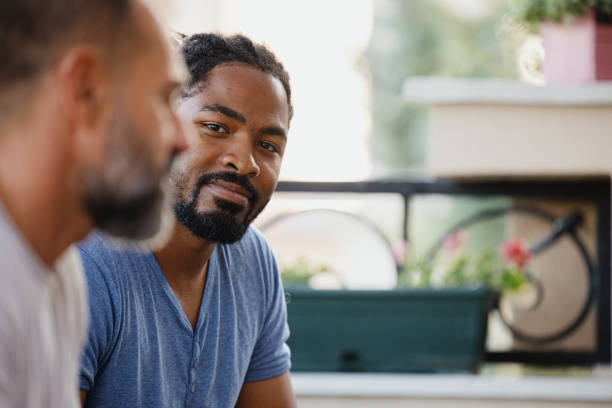 istock Psychotherapist listening to his group during session 1344282662