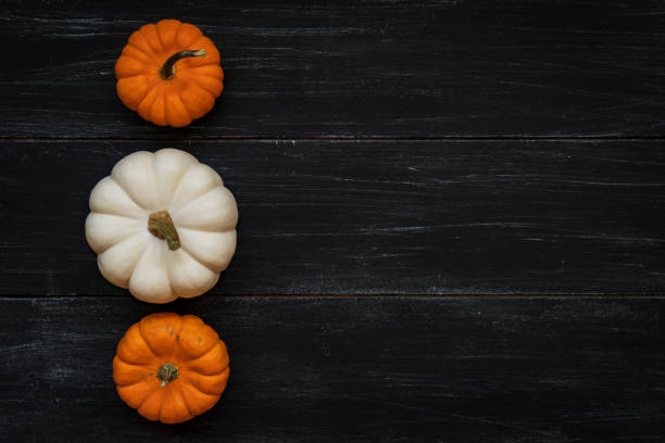 A vibrant assortment of rustic pumpkins fills the marketplace, showcasing a rich spectrum of orange hues. Their unique shapes and textures celebrate the essence of autumn.