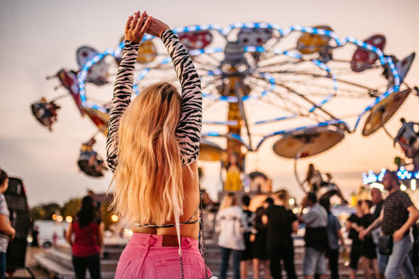 Young beautiful Woman Having Fun in Amusement Park.