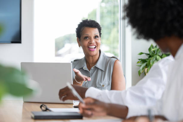 istock Mature female executive in board room meeting 1344289510