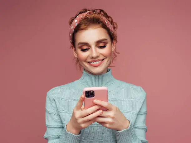 Photo of Close-up portrait of a young pretty girl using smart phone