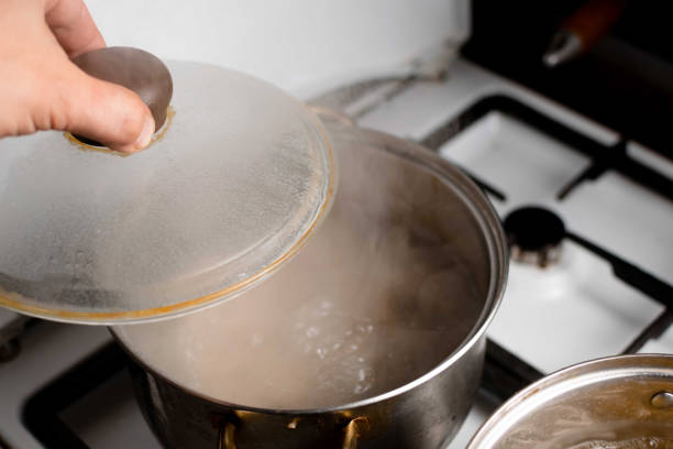 istock An old saucepan with boiling water and an open lid. 1344289680