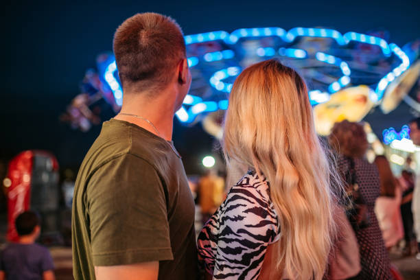 istock Young couple in amusement park 1344289695
