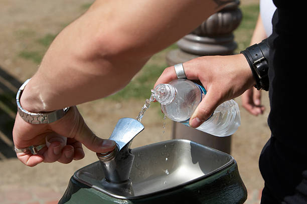 istock Filling water bottle from spout 134428970
